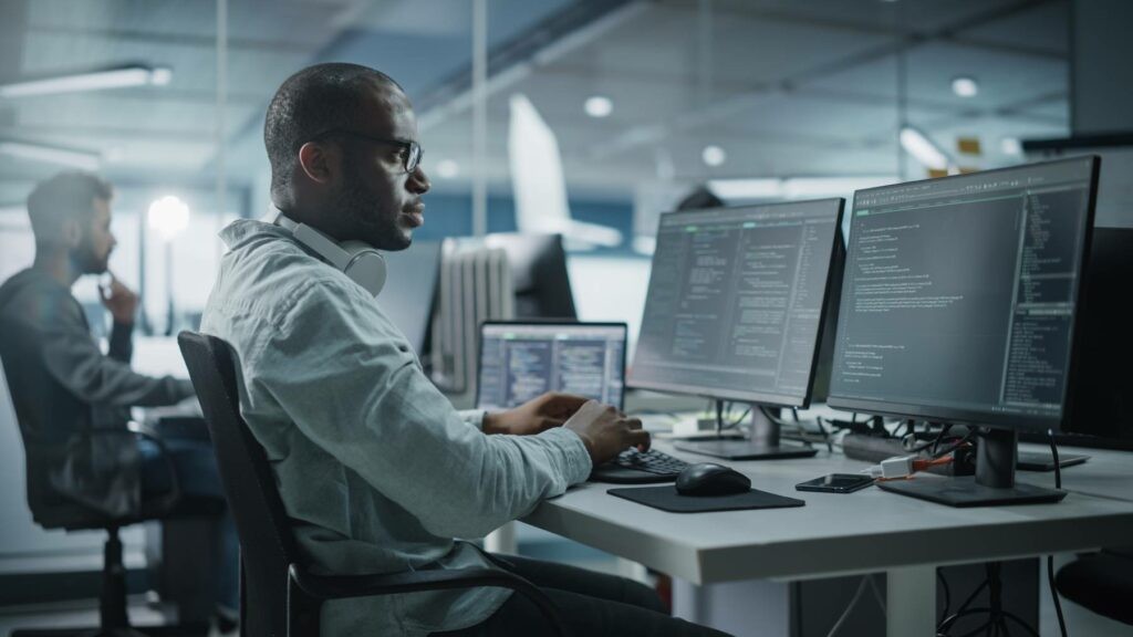 Man sitting at his office desk, working on a computer