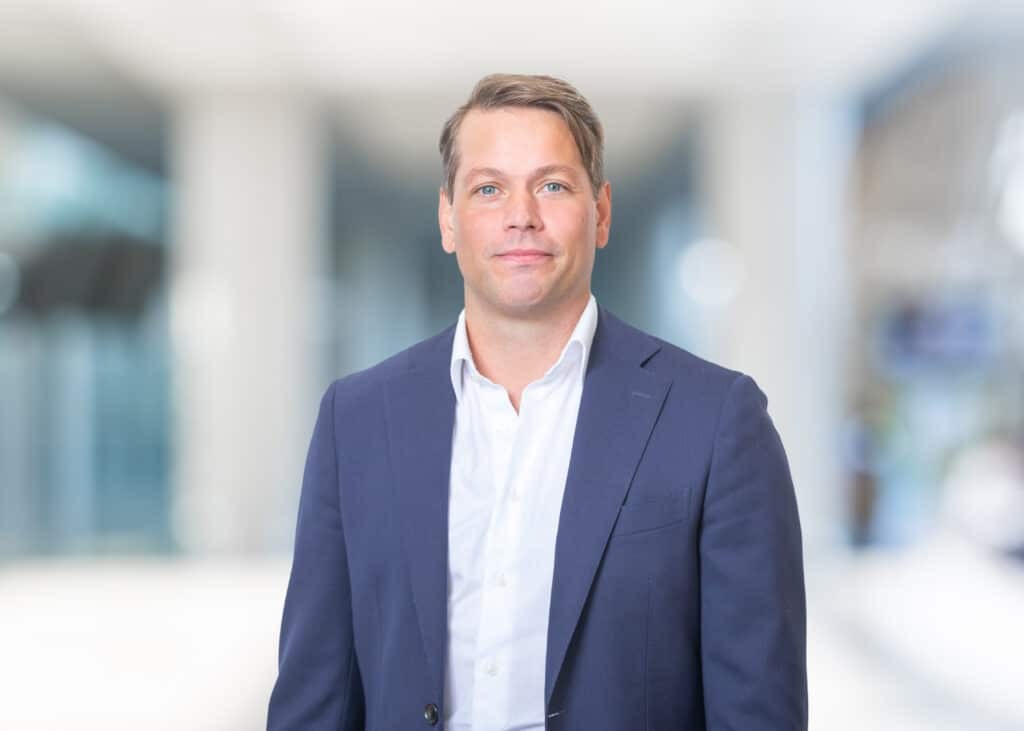 Tim Haaijman, professional headshot of a smiling man wearing a suit