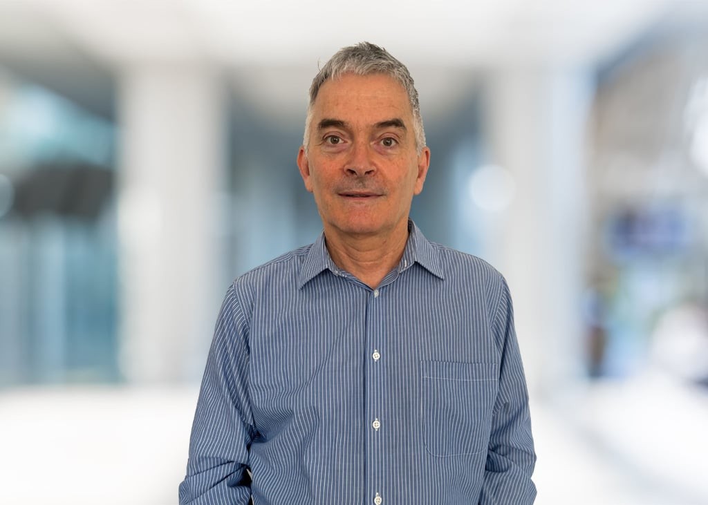 Ian Clark, professional headshot of a smiling man wearing a blue shirt